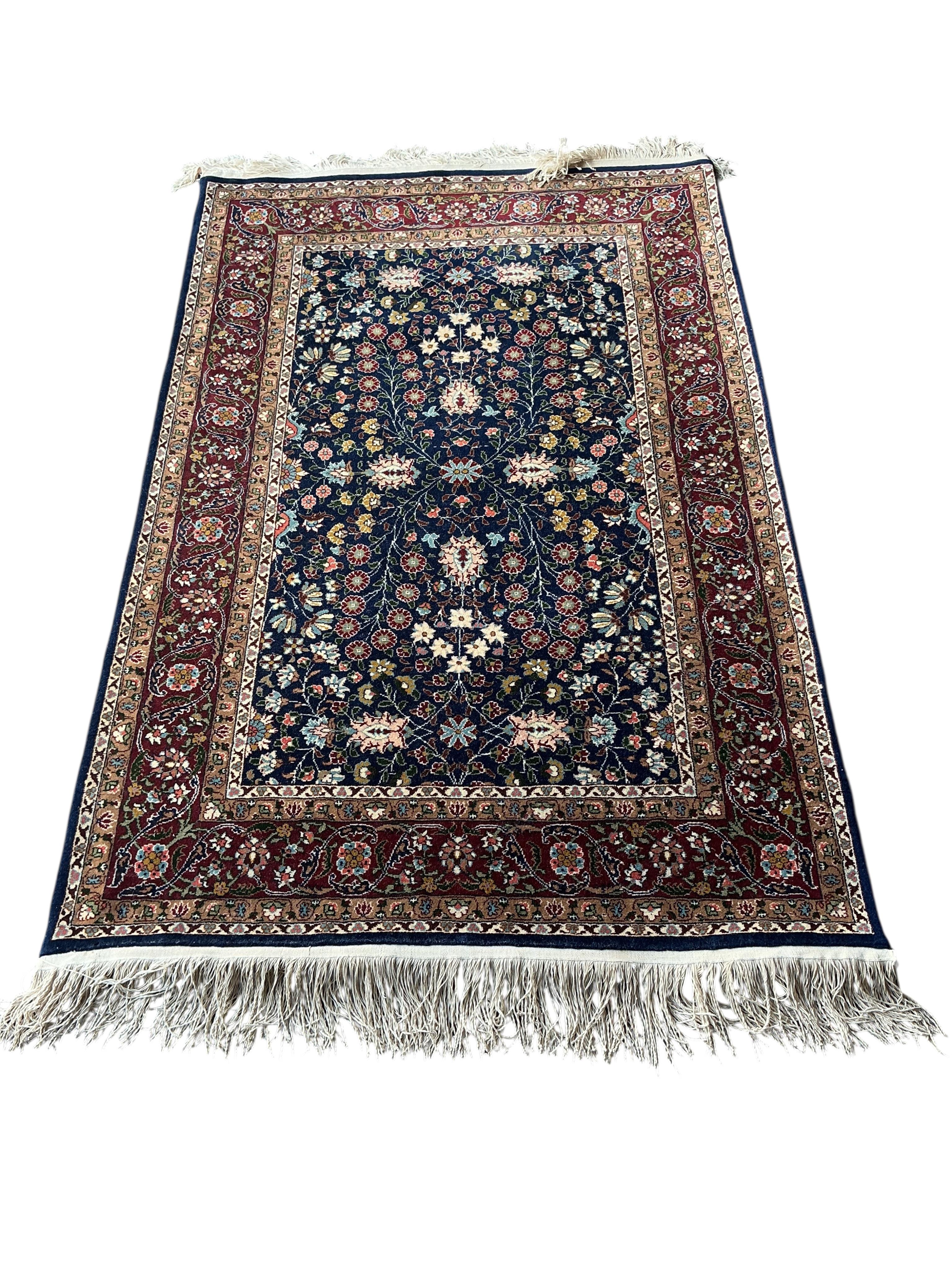 A Hereke Turkish blue ground rug, 150 x 100cm